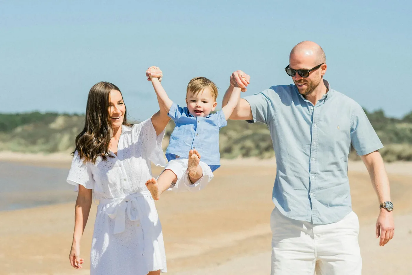 Family walking along a sandy beach